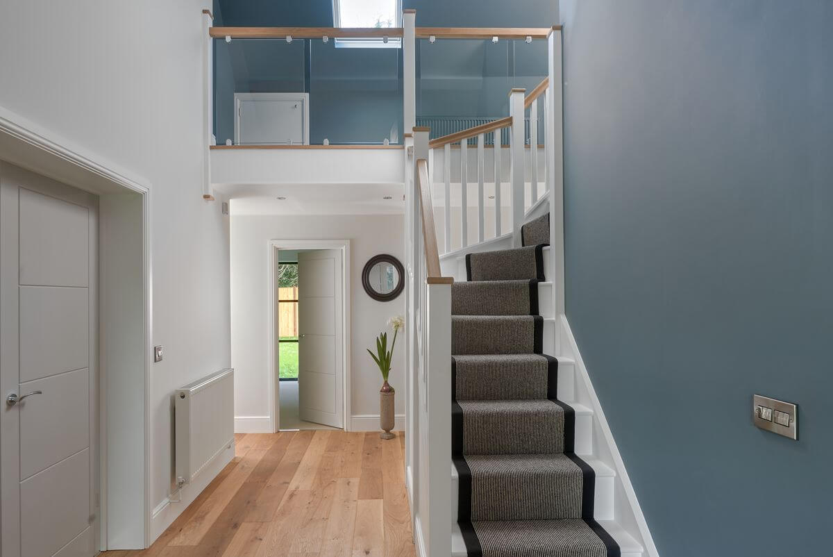 Hallway with glass balustrade staircase